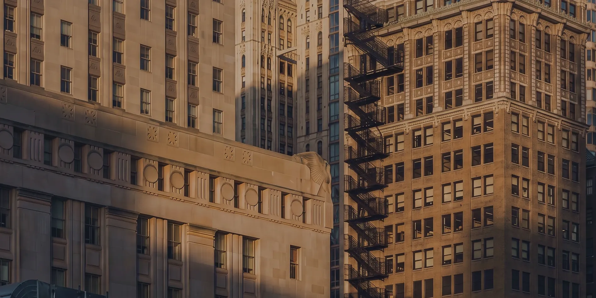 Sunlit stone and brick office towers in a city financial district